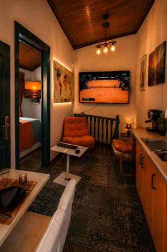 a living room with a kitchen and a bedroom with a bed at Melis House - Lake View, 75'' TV Live Football, Free Parking in Ioannina