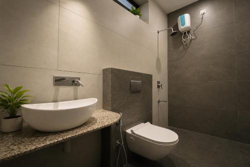 a bathroom with a sink and a toilet at VANVASS - A Forest Resort By Rovers in Rāma
