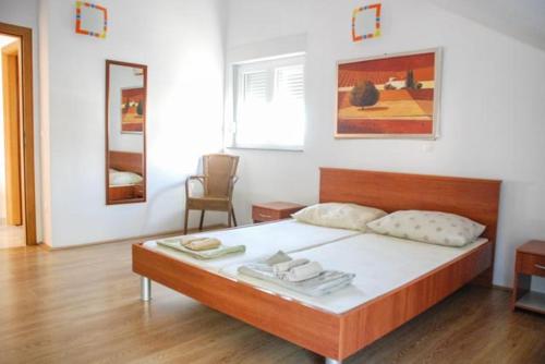 a bedroom with a large bed with white sheets at Danica Roof in Tučepi