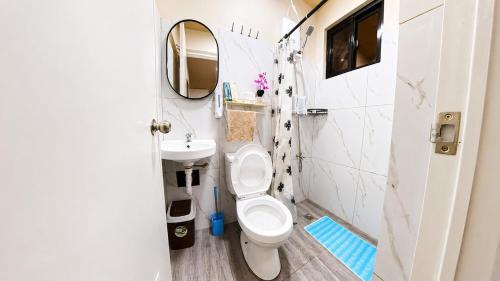 a small bathroom with a toilet and a sink at CLBC Residences - 2B in Ibaba