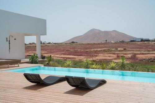 a swimming pool with a view of a mountain at Villa Karuna by Aura Collection in Villaverde