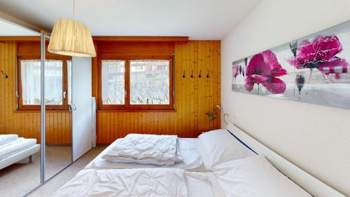 a bedroom with a white bed in a room at Haus Belstar A in Naters