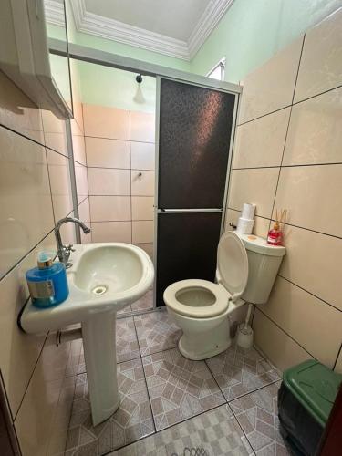 a bathroom with a toilet and a sink at Hotel Marajoara Breves in Breves