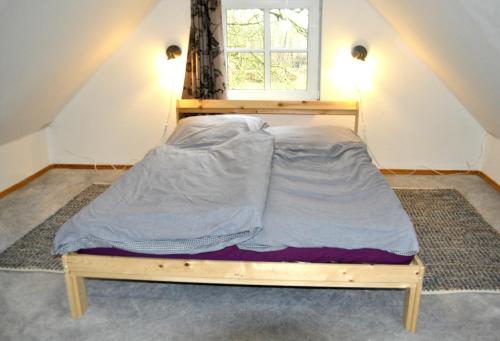 a bed in a room with a window at Cafe-Kuckuck in Salzwedel