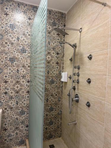 a shower with a glass door in a bathroom at Villa Amoun,Beachfront Villa & sea view,North Coast in Sidi Kirayr
