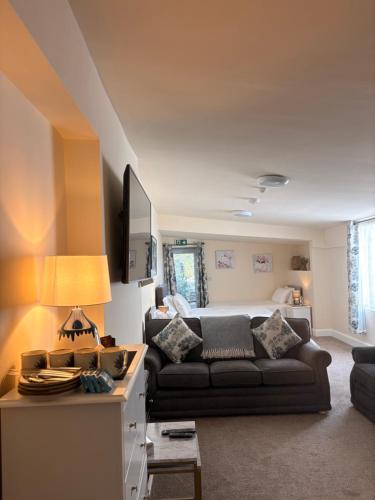 a living room with a couch and a bed at Fahertys bar rooms in Oughterard