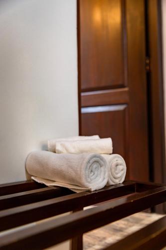 a pile of towels sitting on top of a table at Villa D55 - A Private Villa with Character & Comfort in Kandy