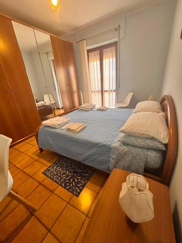 a bedroom with a bed in a room with a mirror at Casa Pianforte - appartamento per vacanze in Bolsena