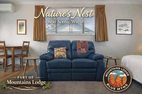a living room with a blue couch and a dining room at Natures Nest near Scenic World in Katoomba