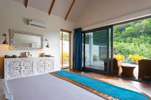 a living room with a large window and a rug at Golden Beach Resort in Koh Rong Island