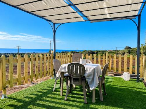 a table and chairs under a canopy on a lawn at Villa Katia - Affittacamere in Torre Marino