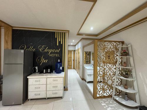 a kitchen with a refrigerator and a sink at Hotel Elegant 2 in Andizhan