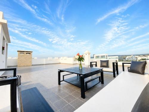 a living room with a table on a roof at Villa Africa in Essaouira