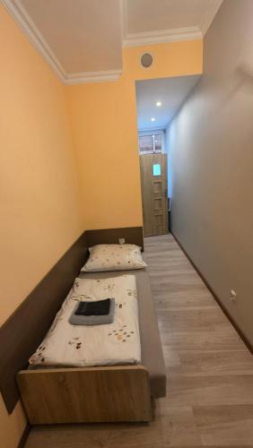 a room with two beds in it with a hallway at Pokoje U Cyngla in Mielec