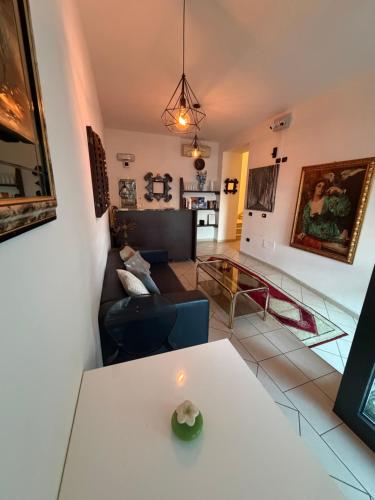 a living room with a table and a couch at M&M Rooms in Pannocchia