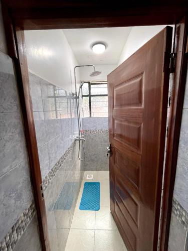 a door leading into a bathroom with a shower at Bay Loft 1 Br Netflix Lake Views, Starlink in Homa Bay