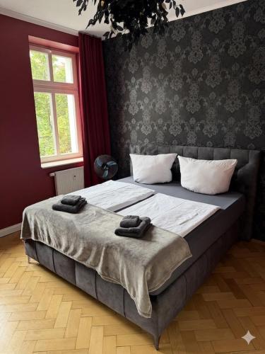 a bedroom with a bed with two towels on it at Exklusives und stilvoll eingerichtetes Apartment für Erwachsene in Bad Liebenwerda
