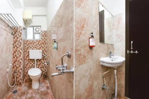 a bathroom with a toilet and a sink at FabHotel Blue Dawn Gachibowli in Gachibowli
