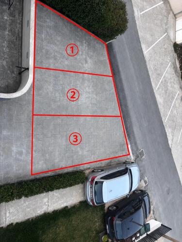 an aerial view of a parking lot with a car at Apartments Silva in Split