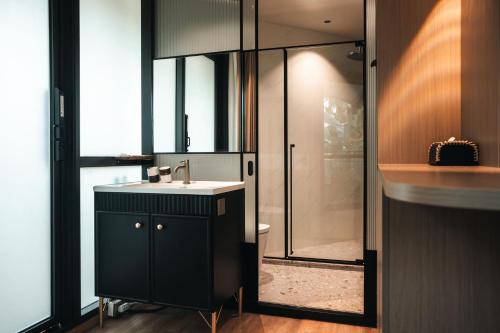 a bathroom with a sink and a glass shower at Seawind Cloudcrest Resort in Semporna