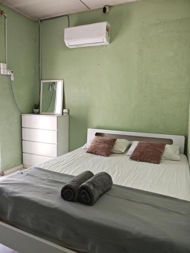 a bedroom with a bed with two towels on it at wawa homestay in Butterworth