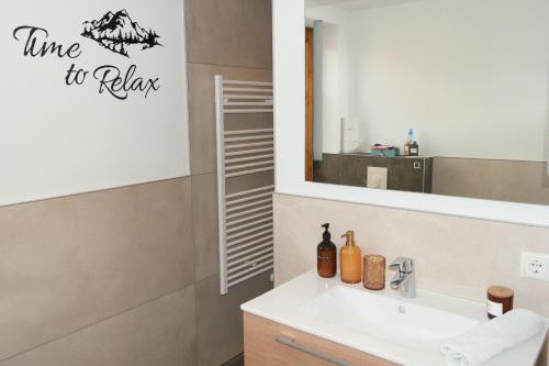a bathroom with a sink and a mirror at Riverhaus in Schladming