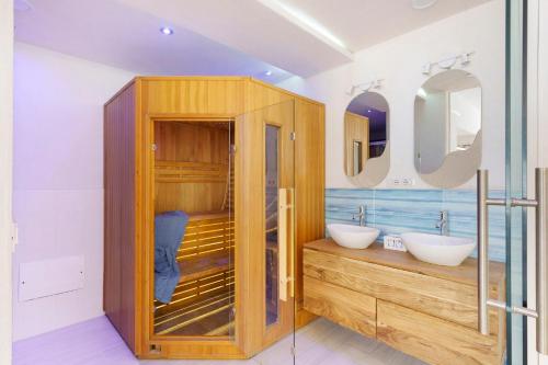 a bathroom with two sinks and two mirrors at Casa Gio & Angie in Forio d'Ischia