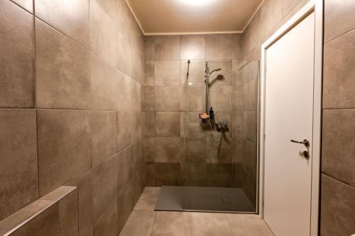 a bathroom with a shower with a glass door at B&B Abbazia di Piona in Colico