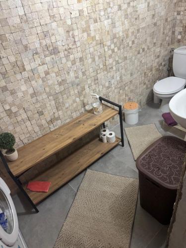 a bathroom with a toilet and a wooden tub at Melisa Garden in Cunda