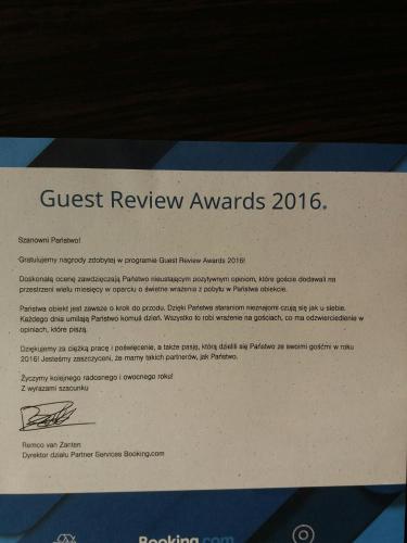 a piece of paper with a guest review awards document at Noclegi Avoca in Pyrzowice