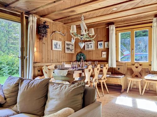 a living room with a couch and a table at Chalet Mutzli by Interhome in Agettes