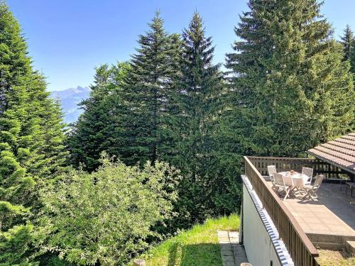 a balcony of a house with a view of trees at Chalet Mutzli by Interhome in Agettes