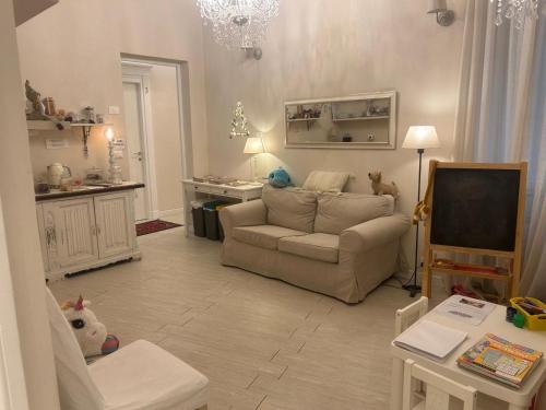 a living room with a couch and a tv at Your House Rooms in Genoa