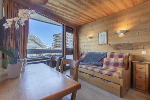 a living room with a couch and a table at Résidence les Cimes - Centre Val d'Isère in Val-d'Isère