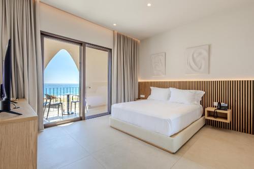 a bedroom with a bed and a view of the ocean at Ulin Boutique Hotel in Borsh