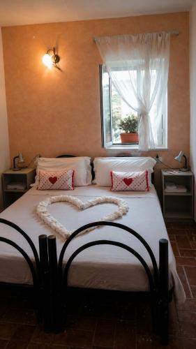 a bedroom with a large bed with a heart madeneauneauigunigunigunigun at Masseria La Rocca in Pacentro