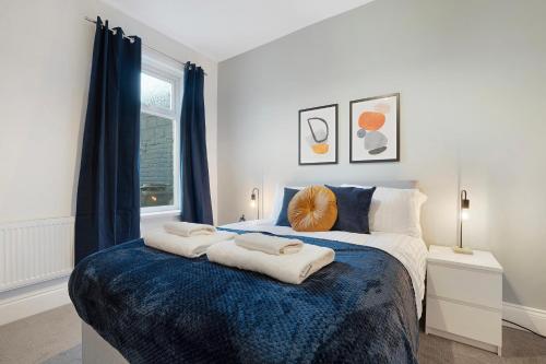 a bedroom with a bed with two towels on it at Sunderland 3BR Retreat Sleeps 6 by Stay With Us in Pallion