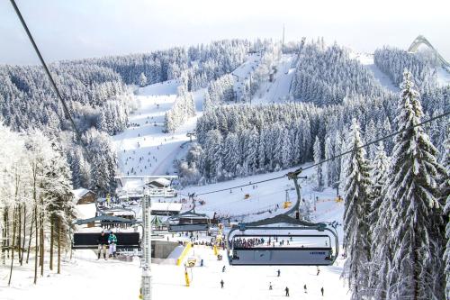 a ski slope with people on a ski lift at Landhaus Gnacke in Schmallenberg