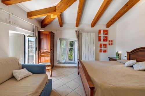 a bedroom with two beds and a couch at Rosa Di Mare Guest House in Finale Ligure