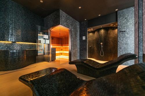 a living room with a couch and a shower at Happy Land Aqua Polanki B407 in Kołobrzeg