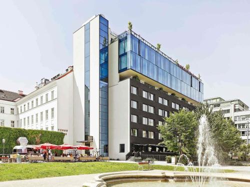 a building with a fountain in front of a building at 25hours Hotel beim MuseumsQuartier in Vienna