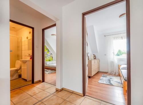 a room with a mirror and a bathroom with a sink at KRAB 2 in Rewal