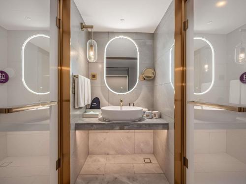a bathroom with a sink and a mirror at Mercure Hefei Huaihe Road in Hefei