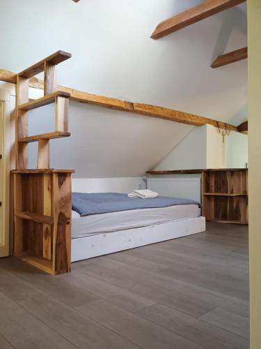 a bedroom with a bunk bed and a ladder at The hayloft in Grohoţele