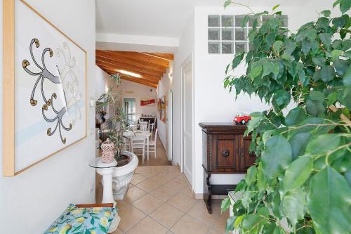 a hallway of a home with a bathroom with a plant at Rosa Di Mare Guest House in Finale Ligure