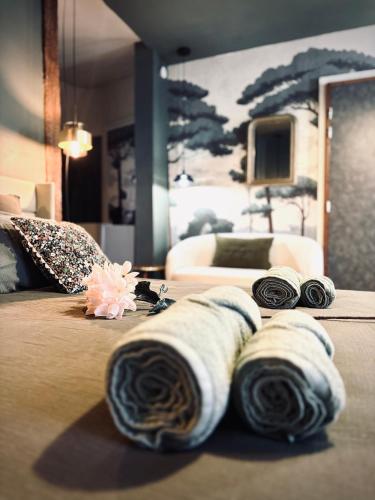 a bedroom with a bed with rolled towels on it at La Suite Archevêché by Collection Signature - Hypercentre Albi - Parking inclus in Albi