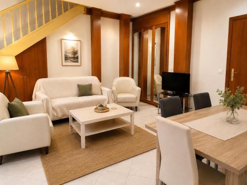 a living room with a couch and a table and chairs at Siena in Preveza