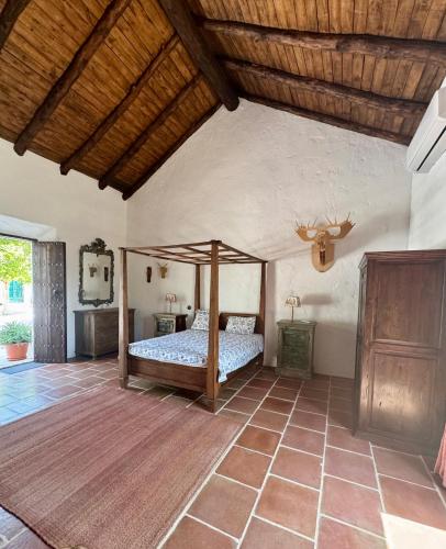 a bedroom with a bed and a wooden ceiling at Palacio de Montellano in Montellano