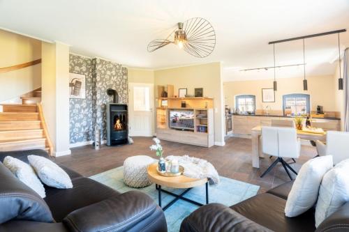 a living room with a couch and a table at Ferienhaus Strandperle in Loddin