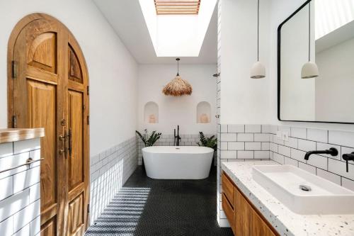 a bathroom with a tub and a sink at The Young Villas - Canggu in Canggu